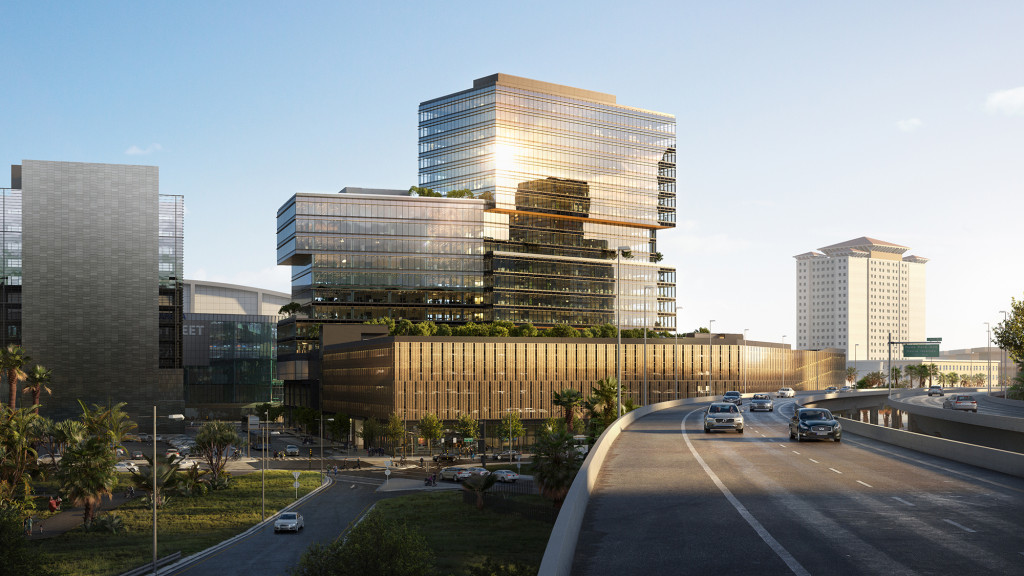 A road with cars and buildings along it.